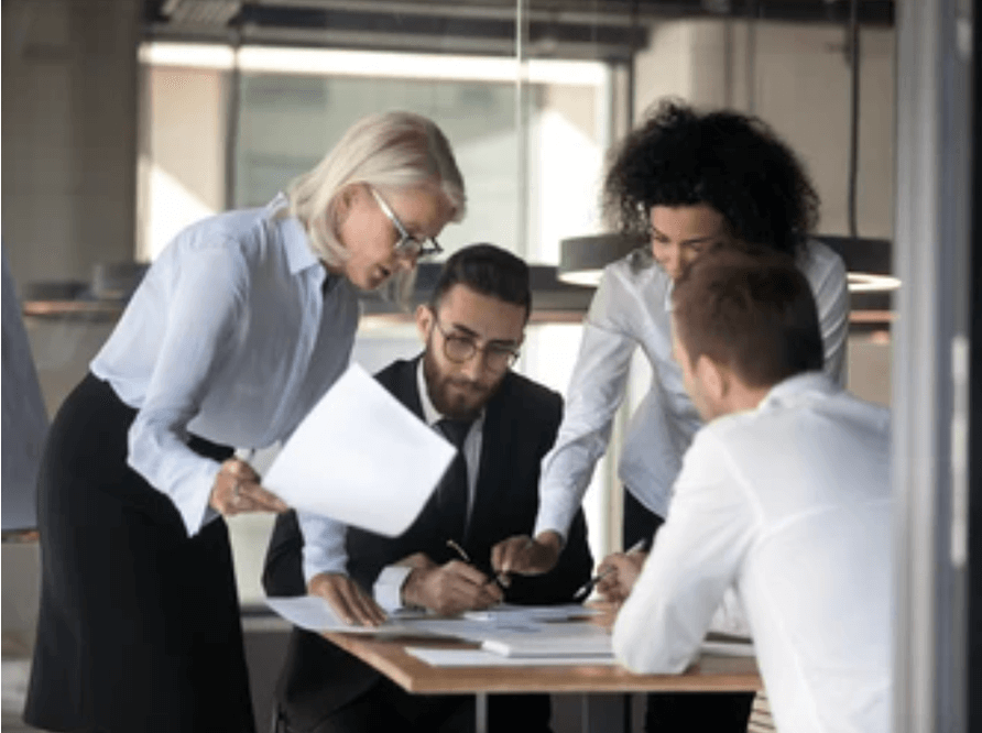 Team collaborating in modern office workspace environment