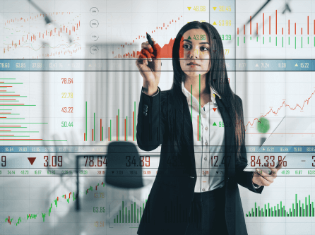 Businesswoman analyzing stock market data on transparent screen
