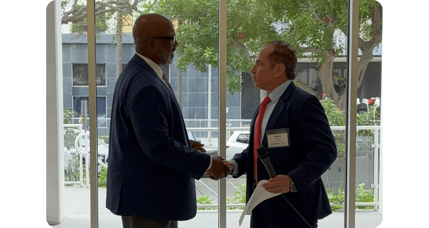 Two business professionals shaking hands in a meeting room