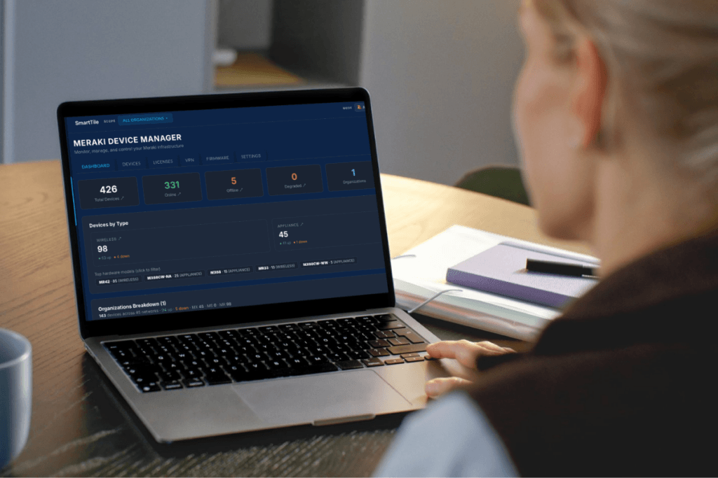 Person using laptop to access Meraki device manager dashboard